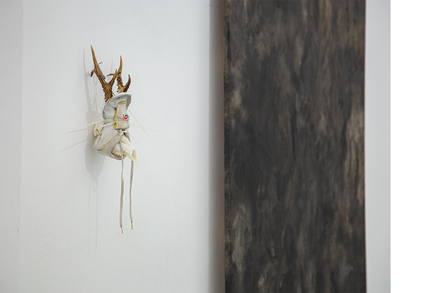 Exhibition views — Idol #6- Mask, 2025 | Mixed media, bones, metal ties, plastic sneakers. 40x30x20.