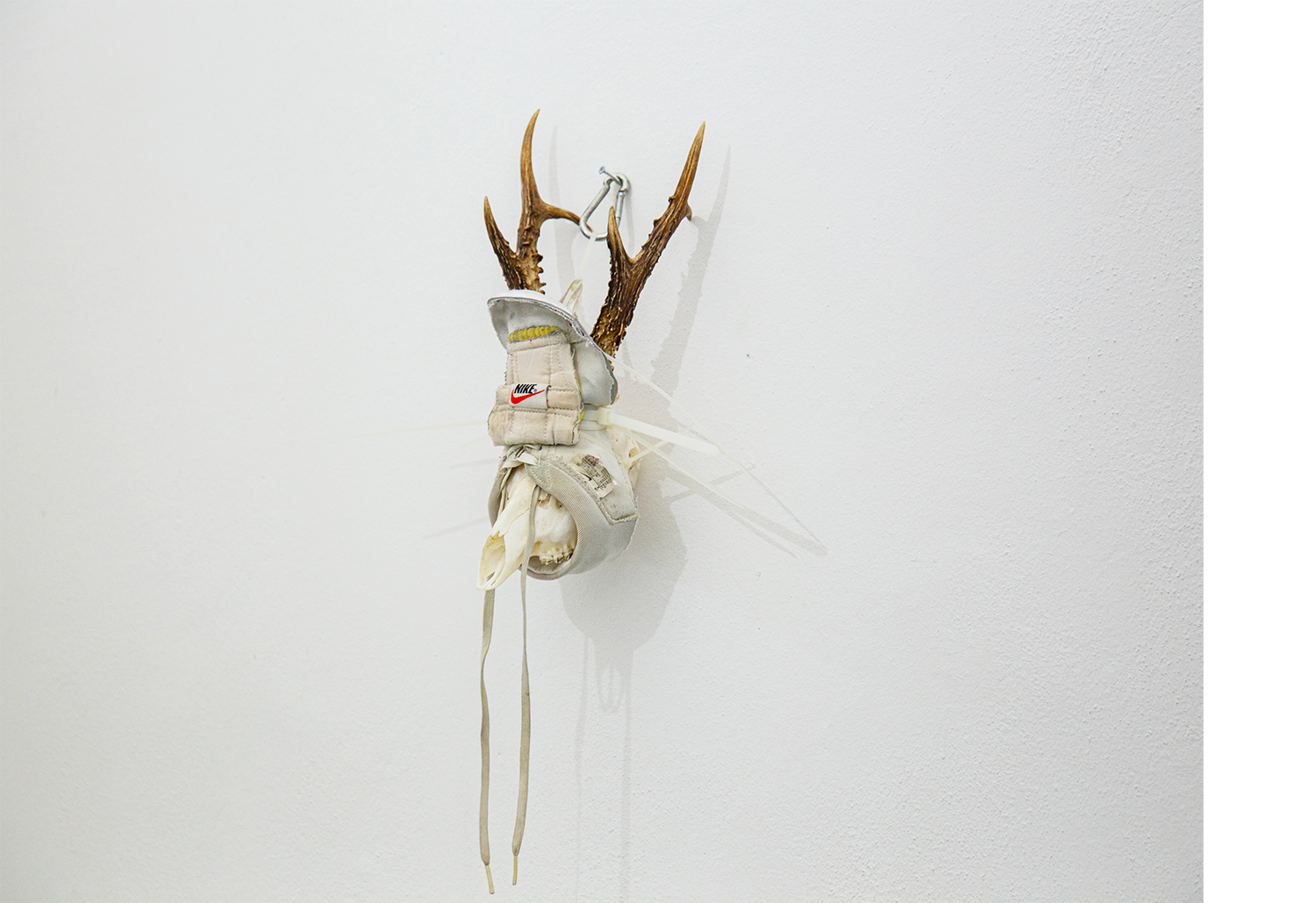 Exhibition views — Idol #6- Mask, 2025 | Mixed media, bones, metal ties, plastic sneakers. 40x30x20.
