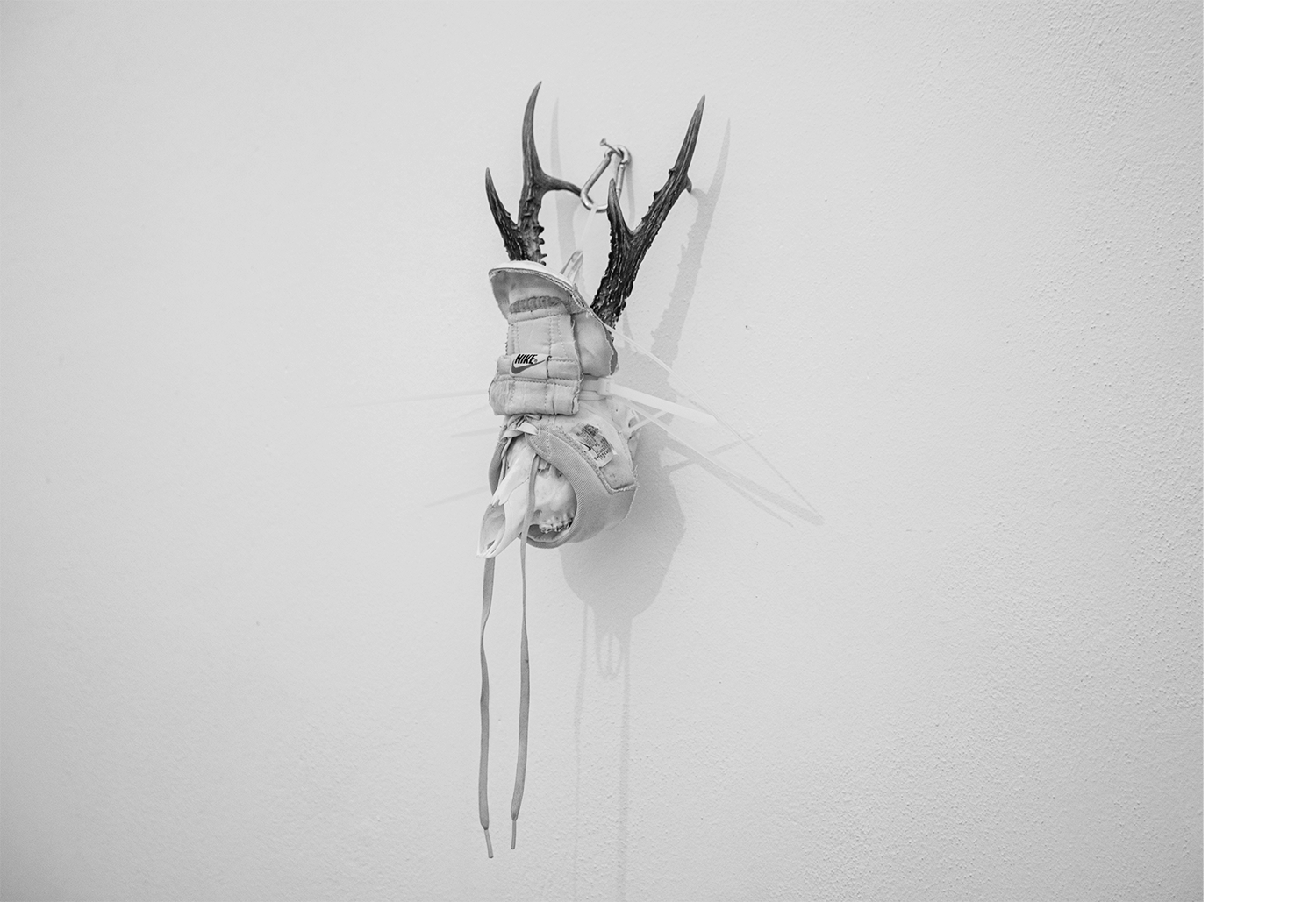 Exhibition views — Idol #6- Mask, 2025 | Mixed media, bones, metal ties, plastic sneakers. 40x30x20.