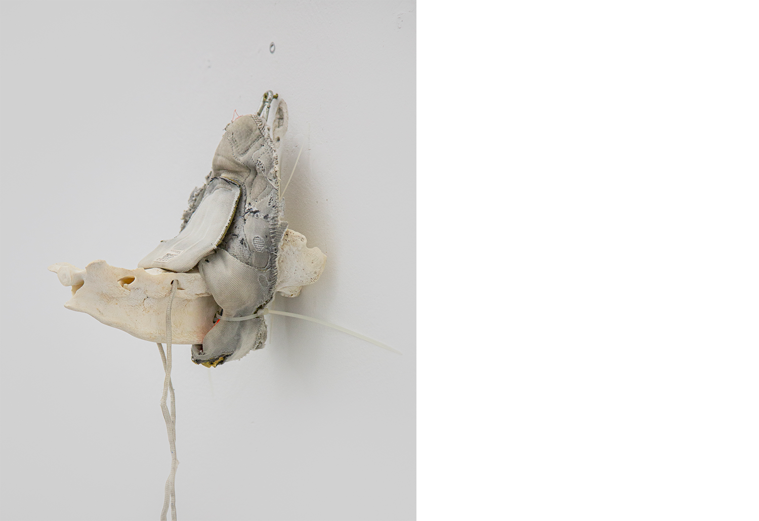 Exhibition views — Idol #8- Pork Mask, 2025 | Mixed media, bones, metal ties, plastic sneakers. 35x40x30