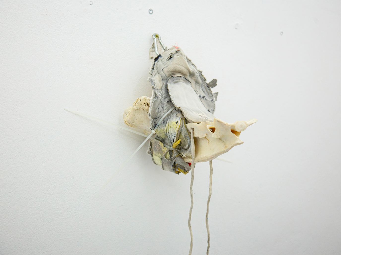 Exhibition views — Idol #8- Pork Mask, 2025 | Mixed media, bones, metal ties, plastic sneakers. 35x40x30